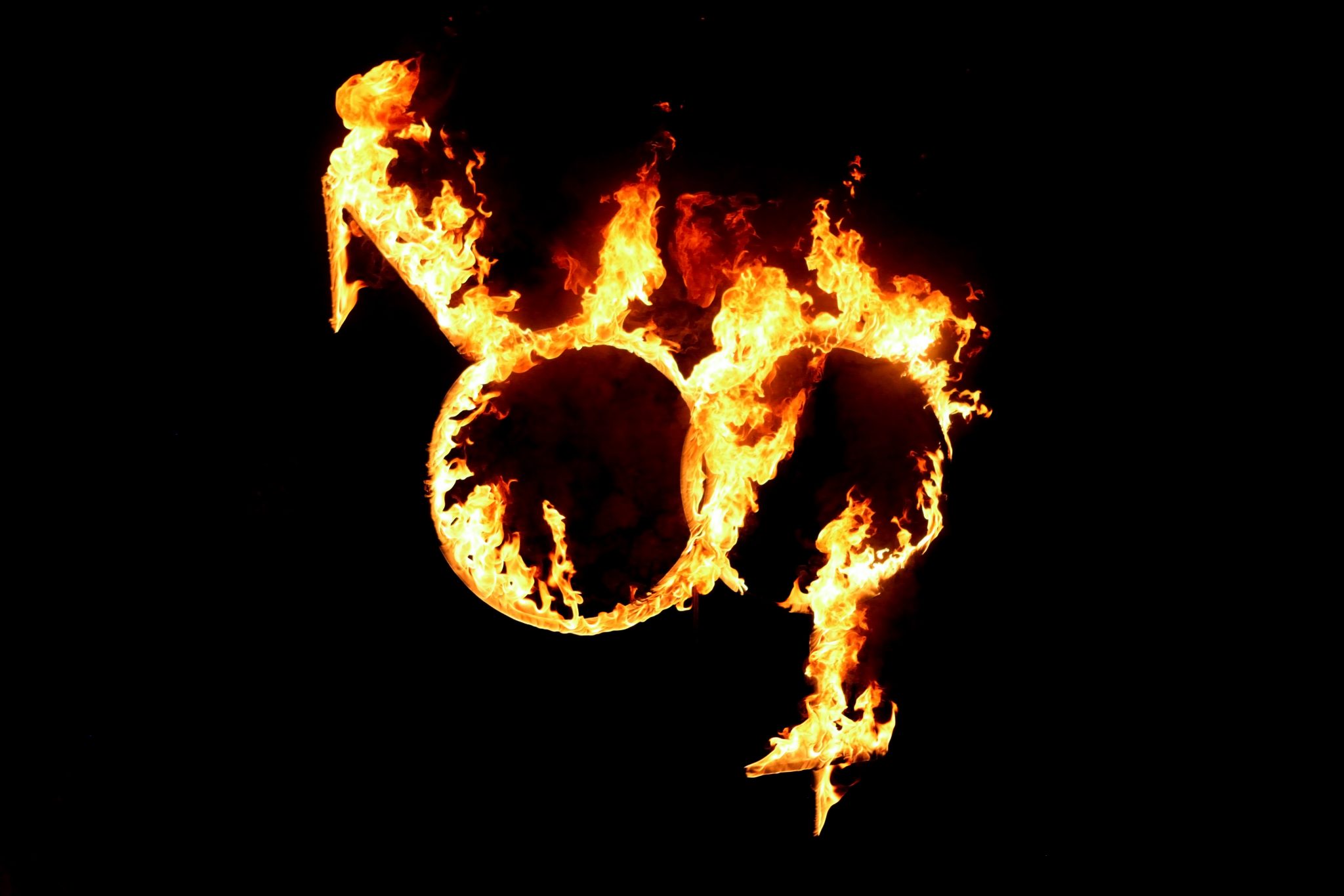 Male and female gender symbols in fire of love
